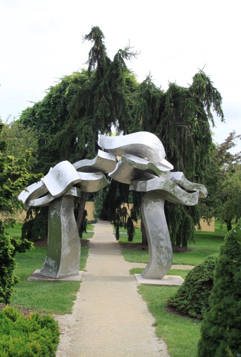 This weeping Norway Spruce nearly exactly mimics the shape of this sculpture.