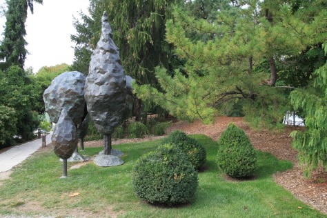 Carefully shaped boxwoods compliment a contemporary sculpture.